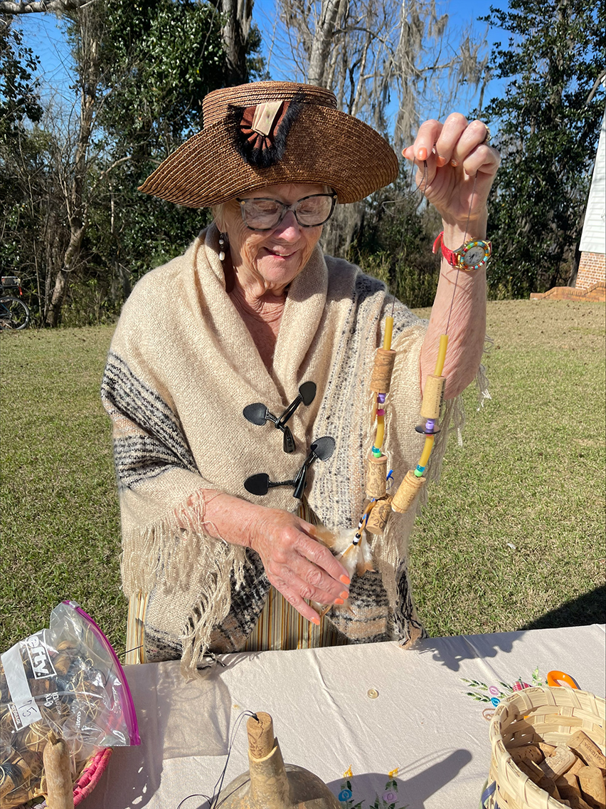 *8) Mary Ellen Shugart of 8) Pensacola was busy making decorative necklaces....
